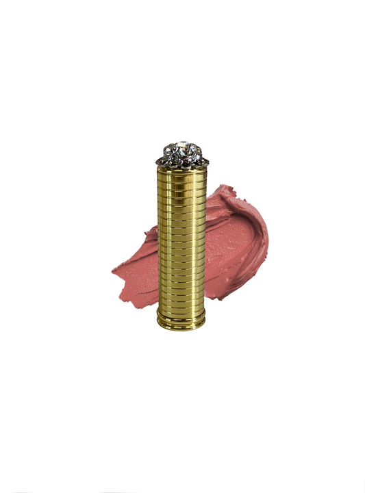 Vintage brass lipstick tube with peach lipstick swatch in shade "Audrey at Tiffanys", the lipstick Audrey Hepburn wore in Breakfast at Tiffanys